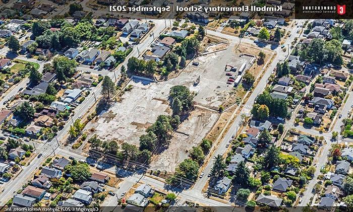 aerial photo of a neighborhood with an empty block sized lot