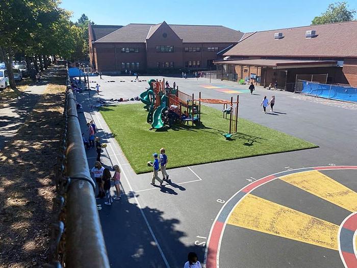 a playground with a play structure and children