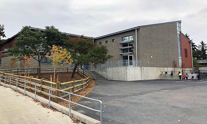 a gray brick building with a ramp