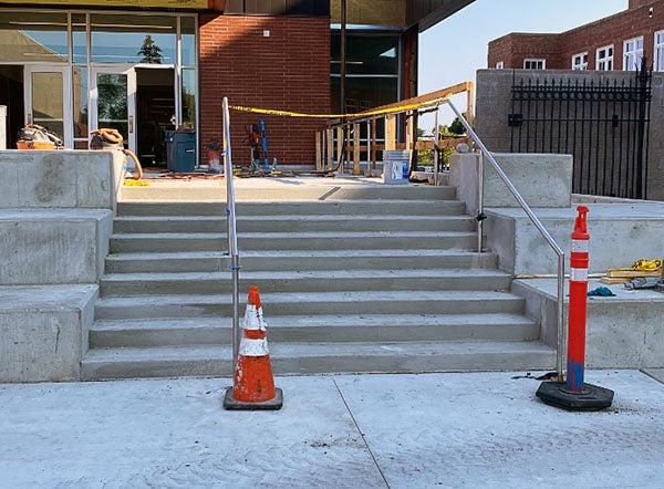 concrete exterior stairs with metal railings