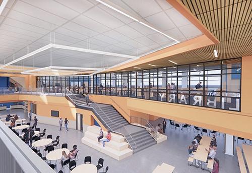 large common area with dining tables and stairs; a room with glass windows looking out toward below says LIBRARY