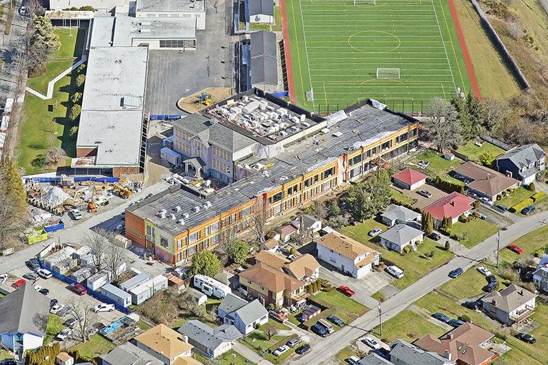 aerial view of a new building wrapped around a historic building