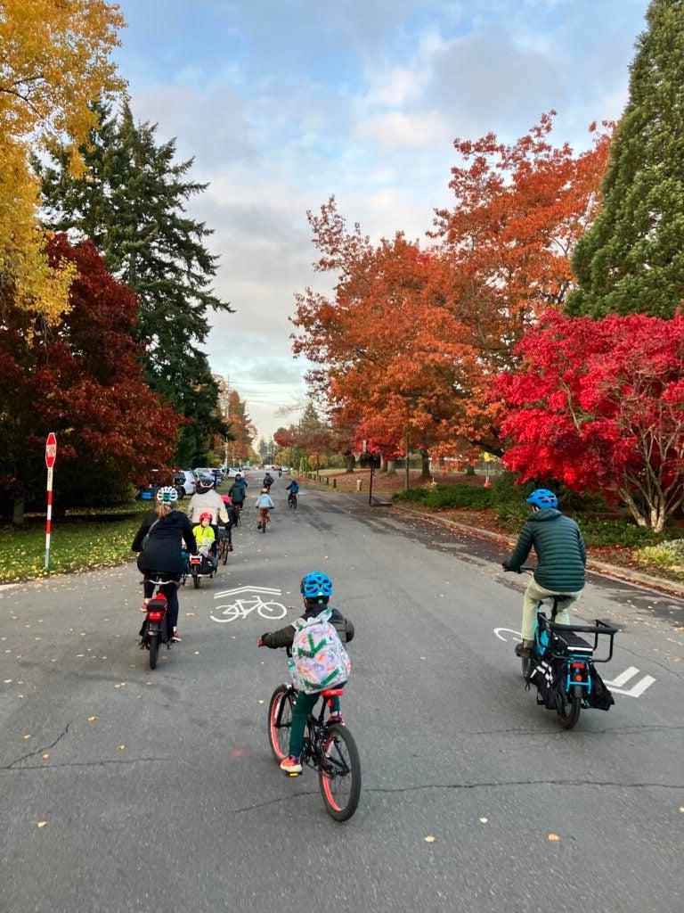 a group of students biking on the street