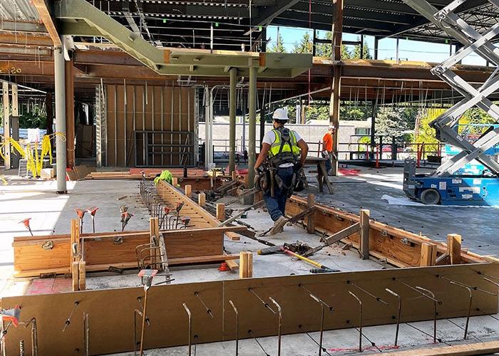 wood framing on a concrete floor inside a partially constructed building