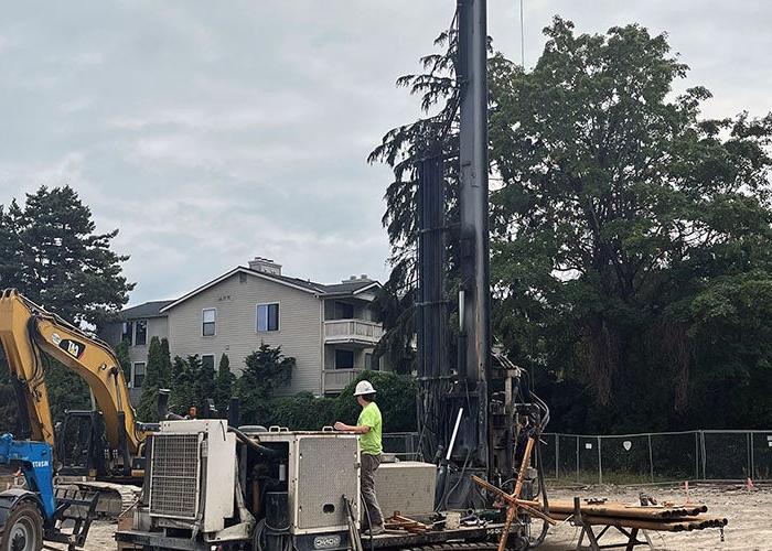 a drill rig with a person operating it