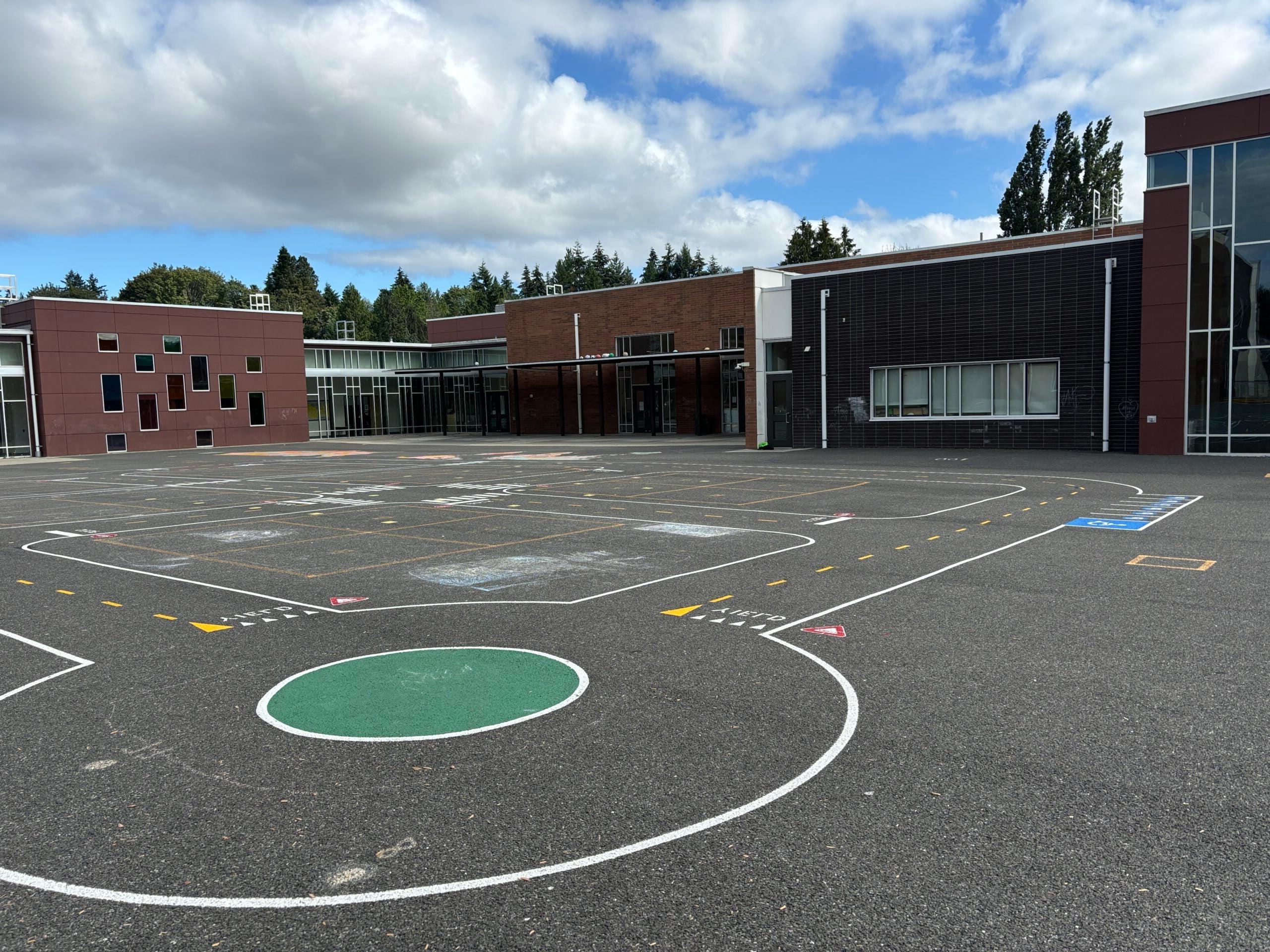 Miniature road with roundabout painted on blacktop.