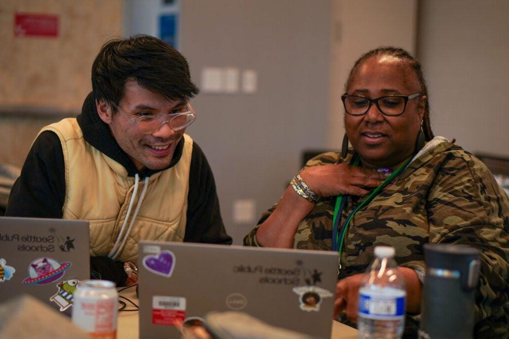 Professional development with industry expert - two people sitting at computers