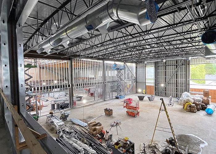 a building under construction with materials on the floor and high ceiling