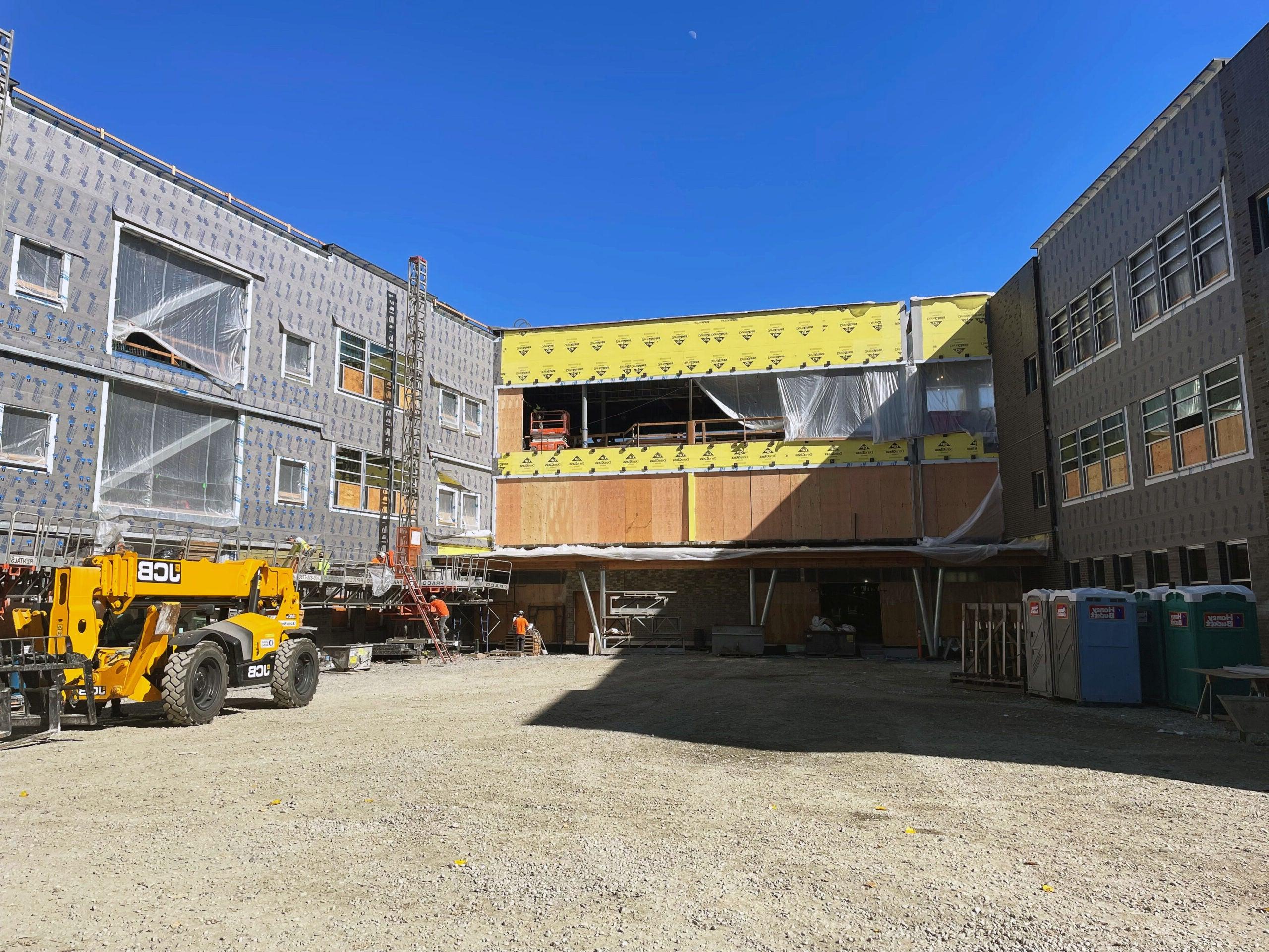 a courtyard space between two wings of a building under construction