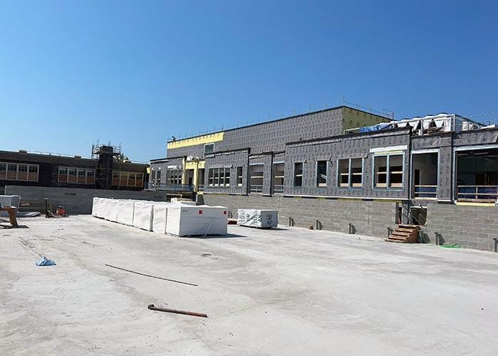 a flat roof with some materials and a building on one side