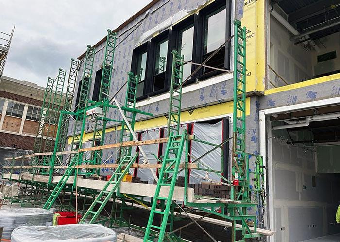 part of a new building under construction with scaffolding