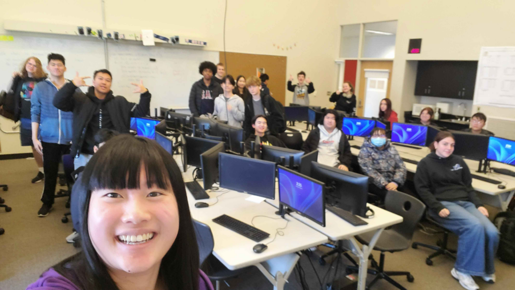 Students pose for a selfie with a UW representative after a session on machine learning