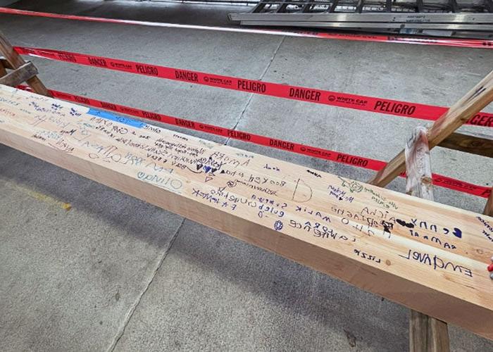 a wooden beam with handwriting on it