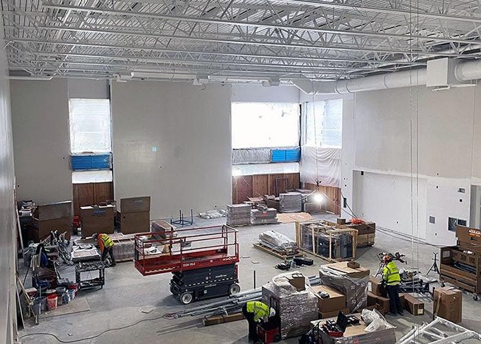 a large room with high ceilings has equipment for construction