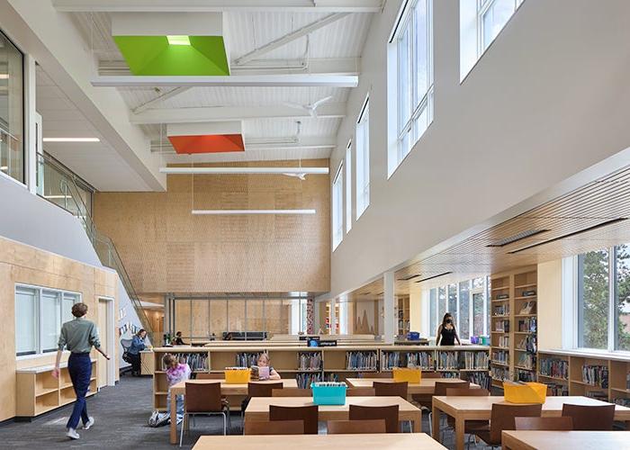 a library with high ceiling and windows