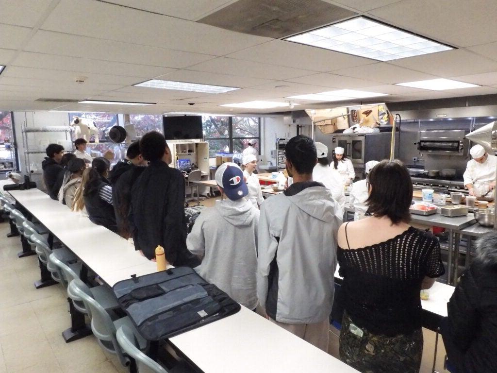 Students standing in line at culinary academy cafeteria