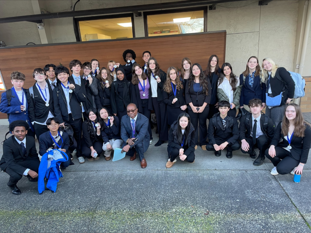 group of students holding medals at competition