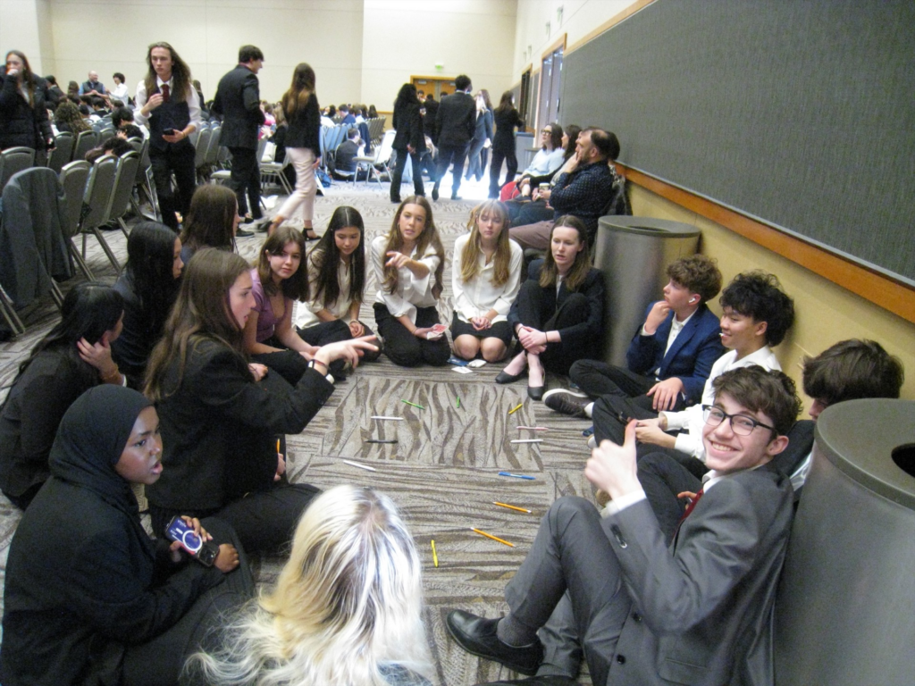 students brainstorming in hallway at competition