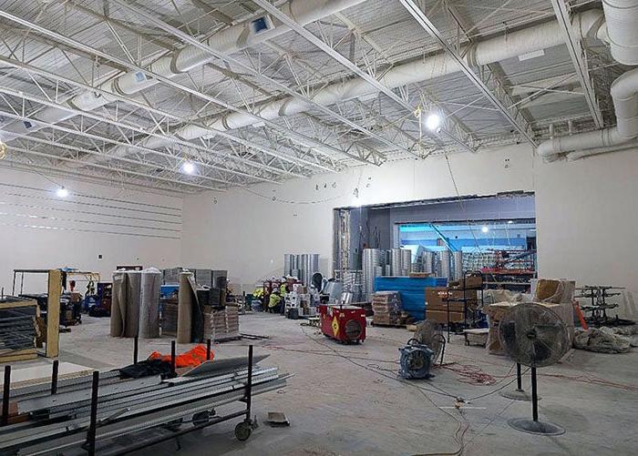 lifts are being used to put in ductwork in a large room