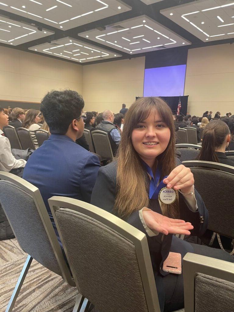 Student holding medal